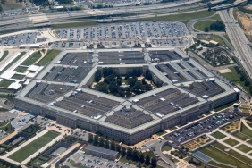 Aerial view of the Pentagon complex with surrounding roads, parking and greenery. g