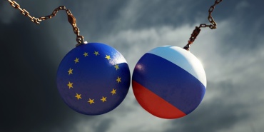 Wrecking Balls Textured with European Union and Russian Flags Over Dark Stormy Sky